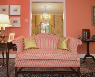 Newly upholstered settee and custom pillows, with our coordinating cornice and drapery in the background.