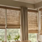 Woven shades provide organic charm, while curtains add softness and sophistication. Together, they offer an effortlessly chic look.