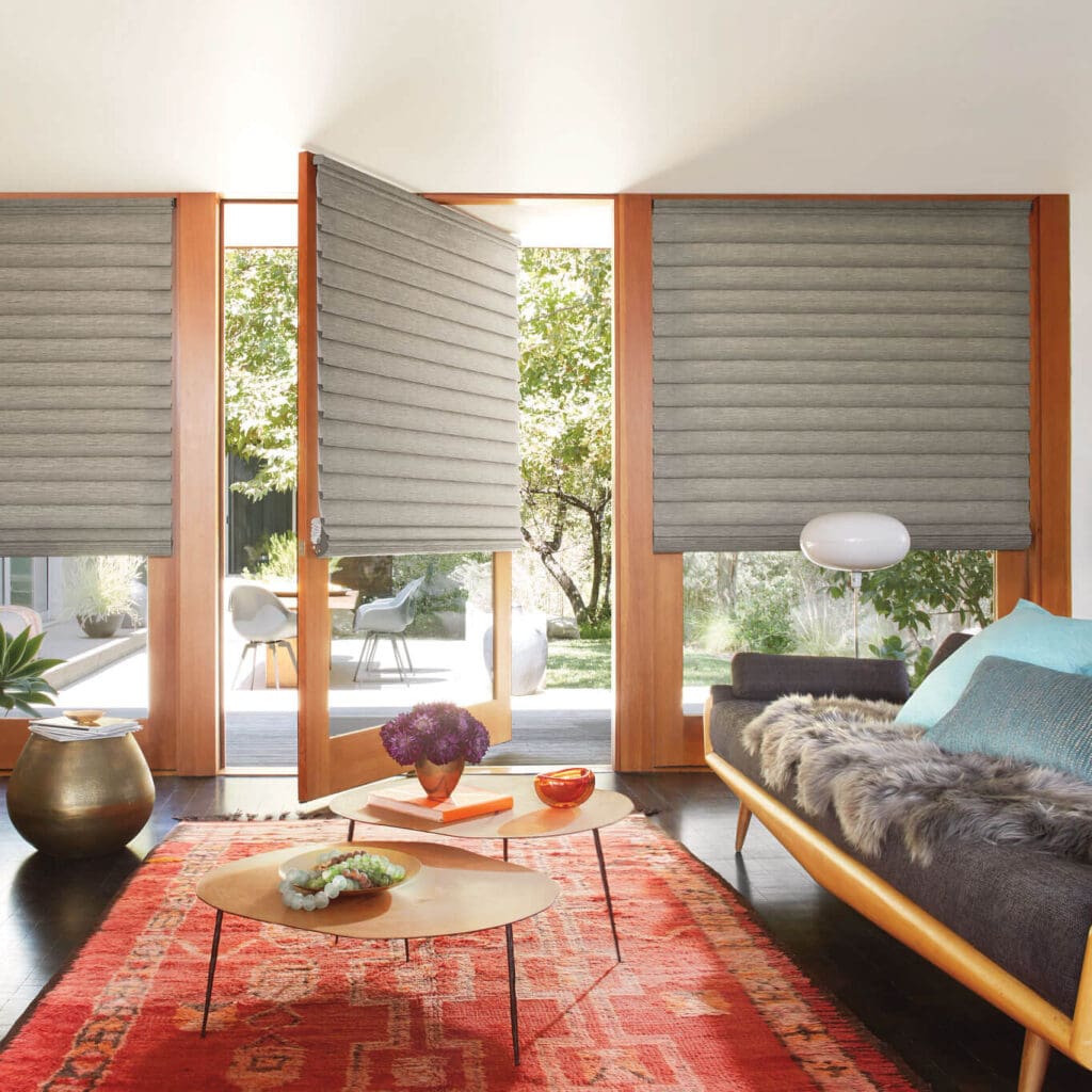 Mid-century modern living room with gray Hunter Douglas Vignette® Roman Shades and a patio door.