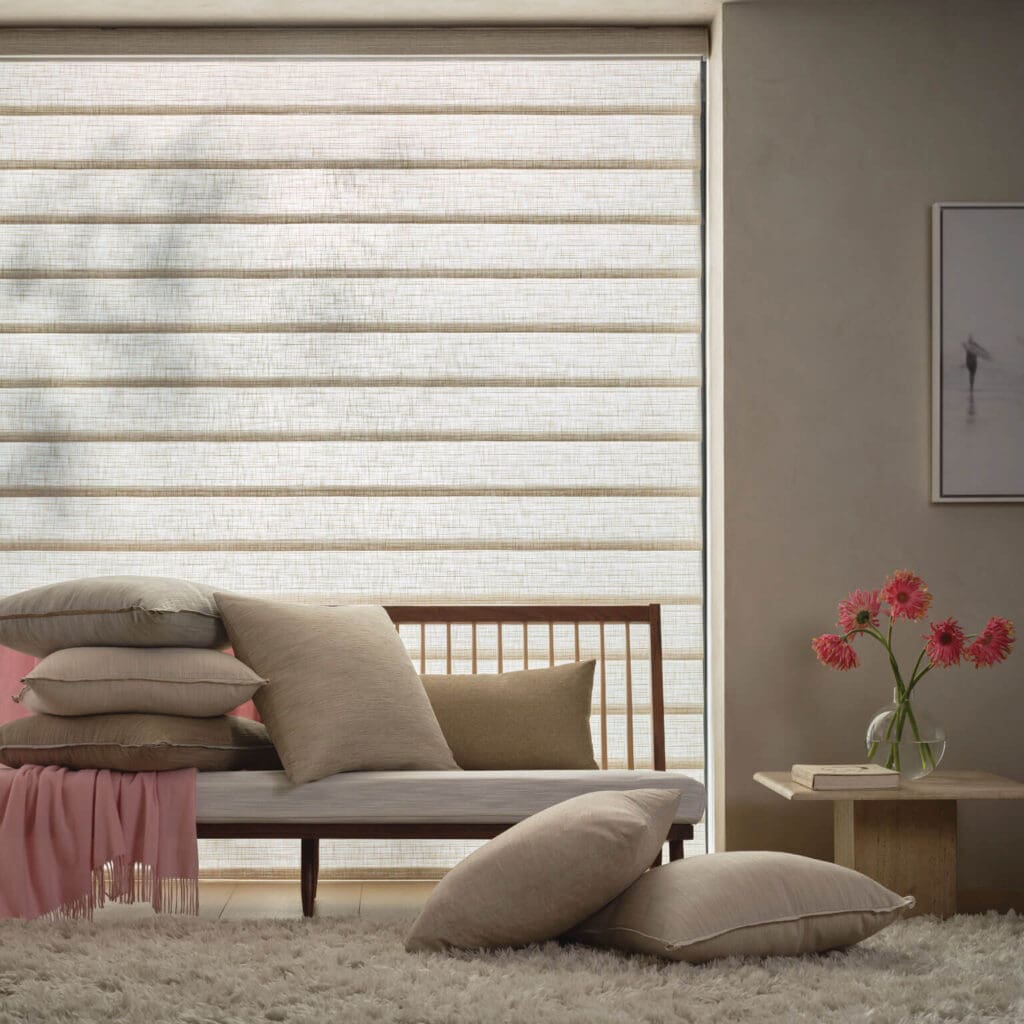 Living area with a Hunter Douglas Roman shade and pillows in coordinating fabrics in North Carolina.