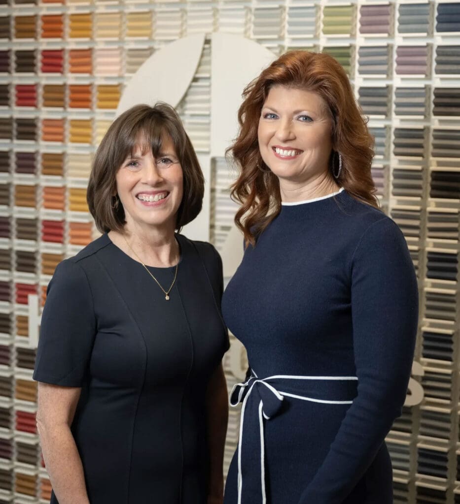 The friendly owners of Window Works Studio, Jamestown, NC, standing in their showroom of custom window treatments.