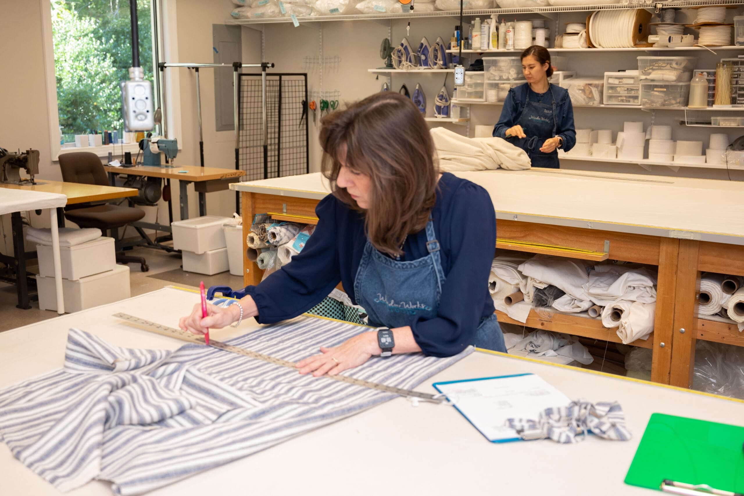 Window Works Studio artisans working with fabric in the custom drapery workroom
