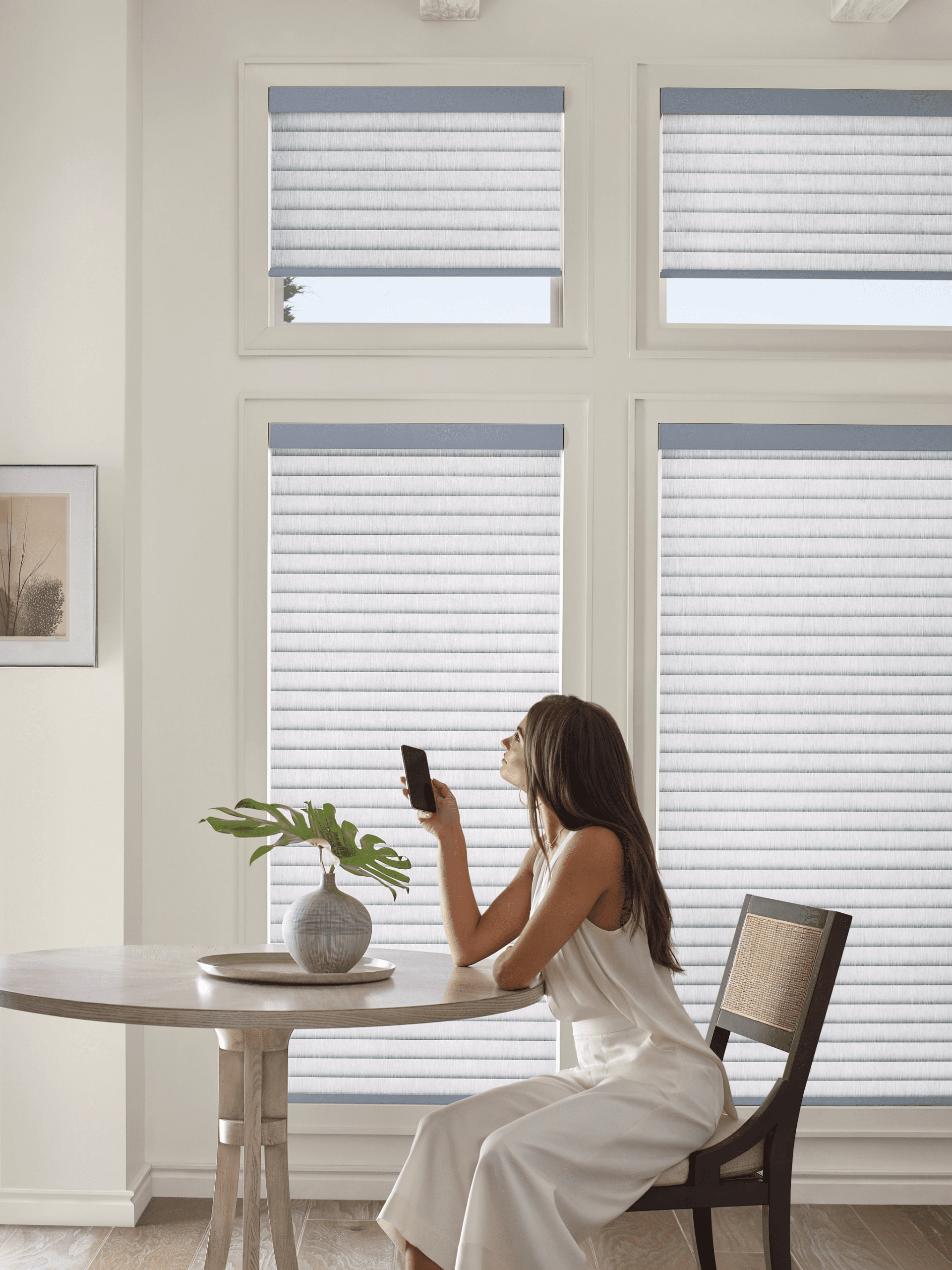 Homeowner using smartphone controls for motorized window shades