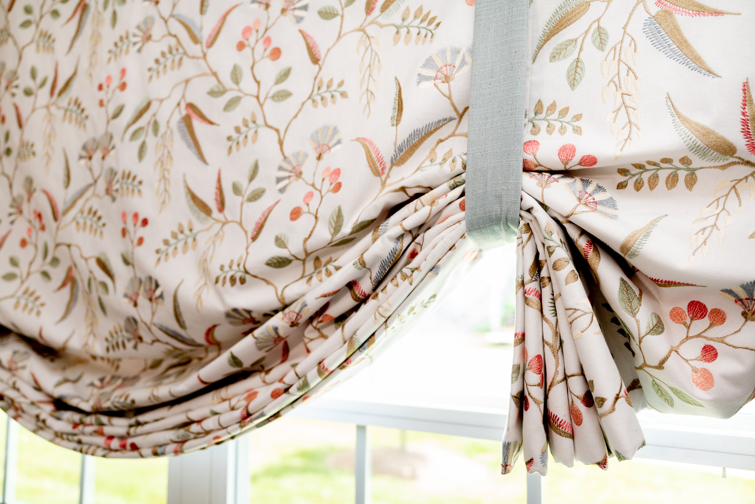 Custom botanical Roman shade showing detailed fabric and craftsmanship